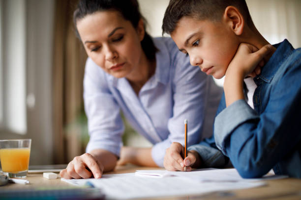 istock Mother helping her son with homework 1035393462