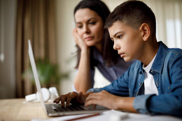 istock Mother helping teenager with homework 1035393644