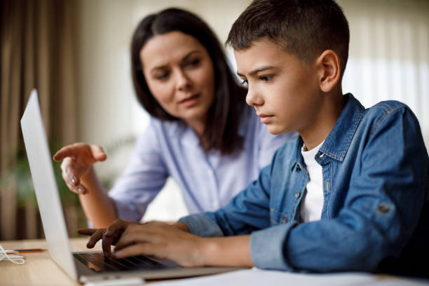istock Mother helping teenager with homework 1035393824