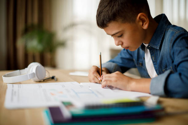 istock Teenage boy doing homework 1035393868