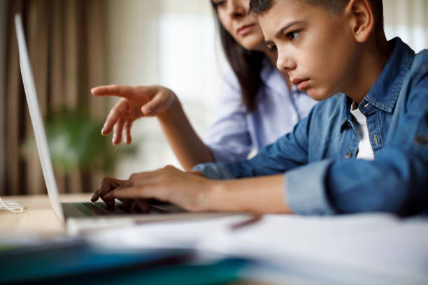 istock Mother helping teenager with homework 1035393874