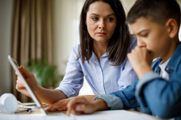 istock Mother helping teenager with homework 1035393876
