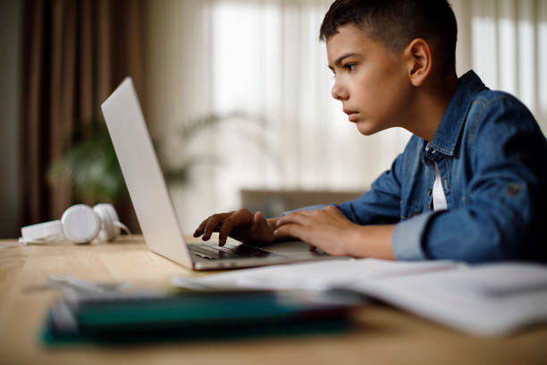 istock Teenage boy using laptop for homework 1035393962