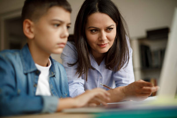 istock Mother and son using laptop at home 1035394046