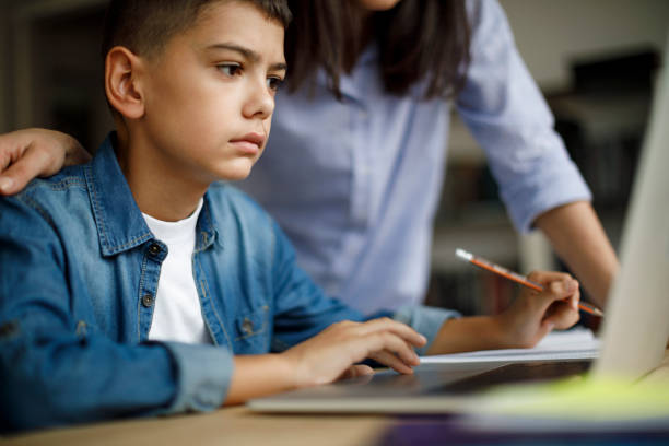 istock Mother and son using laptop at home 1035394088