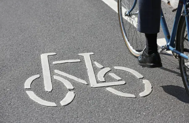 cyclist beneath pictogram on cycle lane