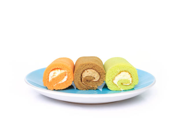 istock green chocolate orange cake roll on blue placed on white background. 1035394286