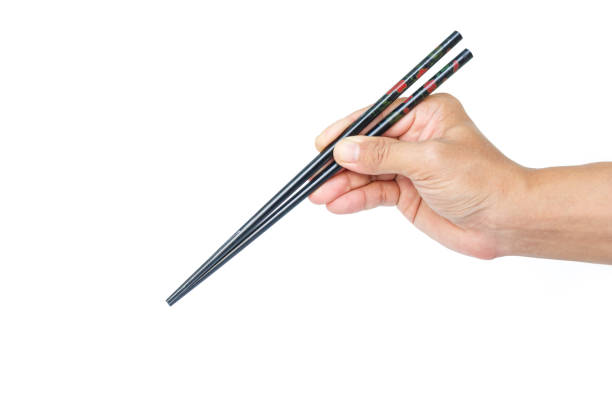 istock hand holding chopsticks tradition chinese japanese on white background 1035397698