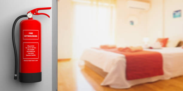 istock Fire extinguisher on a wall, blur hotel room background. 3d illustration 1035403322