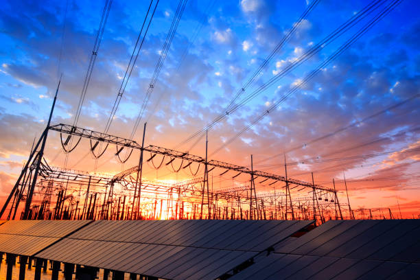 solar photovoltaic panels and substations in the evening - torre de transmissão de eletricidade imagens e fotografias de stock