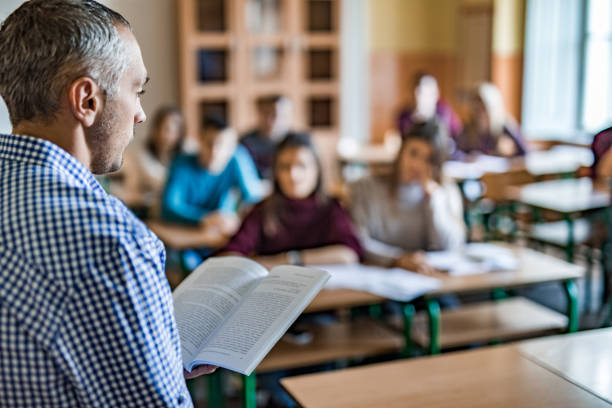 istock Male professor teaching a lecture to high school students in the classroom. 1035404058