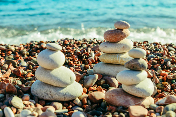istock balanced rocks at seaside. rocky beach on sunset. 1035408088