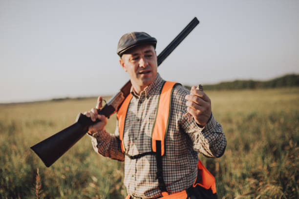 istock Hunter holding prey. Hunter holding quail 1035410560