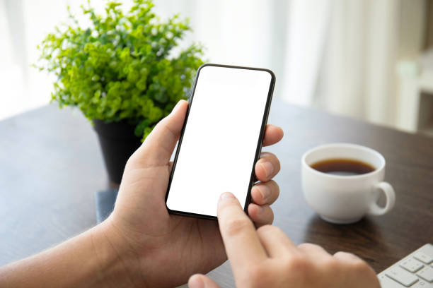 istock man hands holding phone with isolated screen in office 1035410624