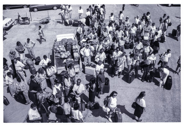 1989 shot of tourist waiting to embark a ferry on Skiathos, Greece