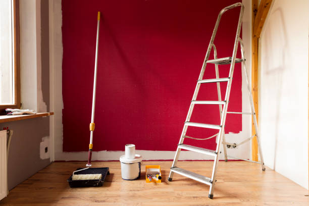 istock Tools for coloring, paint roller, brush, aluminium leader. Wall partly collored. 1035413794