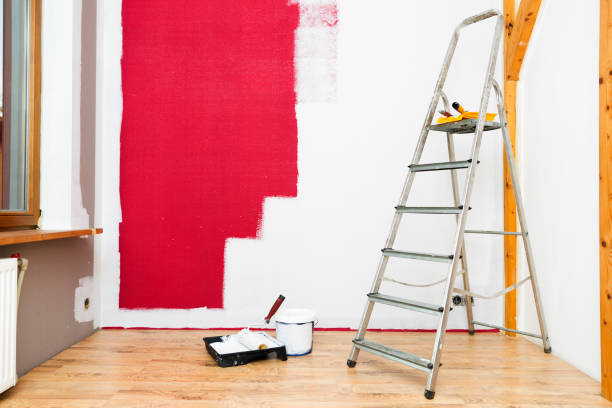 istock Tools for coloring, paint roller, brush, aluminium leader. Wall partly collored. 1035414216