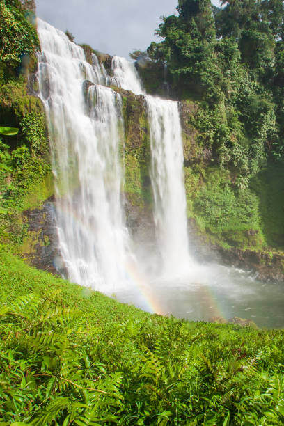 istock Great waterfall scenery with a rainbow. Tad Yuang, dramatic waterfall drops 40 metres over a cliff and tropical forest. Bolaven Plateau, Paksong, Laos. Rainy season. 1035414232