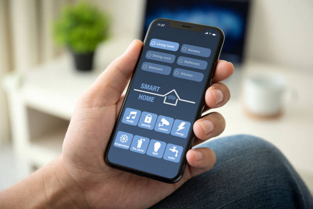 istock man hand holding phone with app smart home in room 1035418330