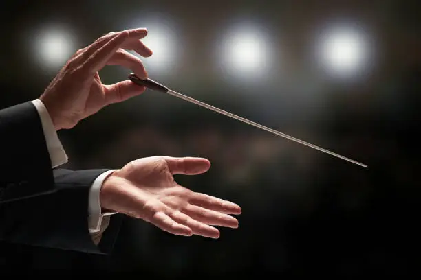 Photo of Conductor conducting an orchestra