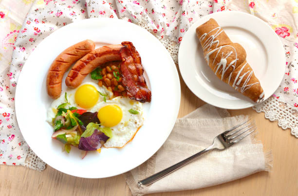 istock Breakfast with eggs, sausages and bacon. Light colors. 1035428212
