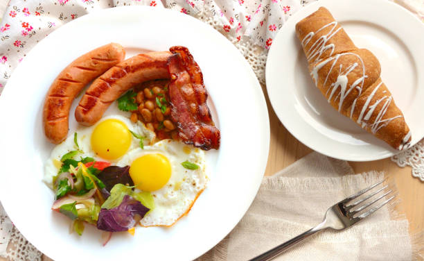 istock Breakfast with eggs, sausages and bacon. Light colors. 1035428612
