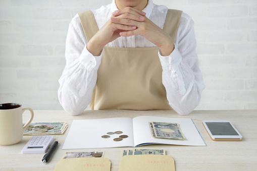 Japanese woman keeping household accounts with smart phone