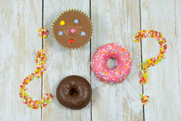 Colorful chocolate cakes on wooden table and sugar stars