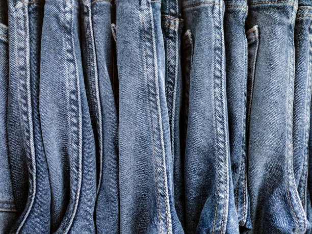 istock stack of various shades of blue jeans.Stacked Denim Clothes background. 1035436236
