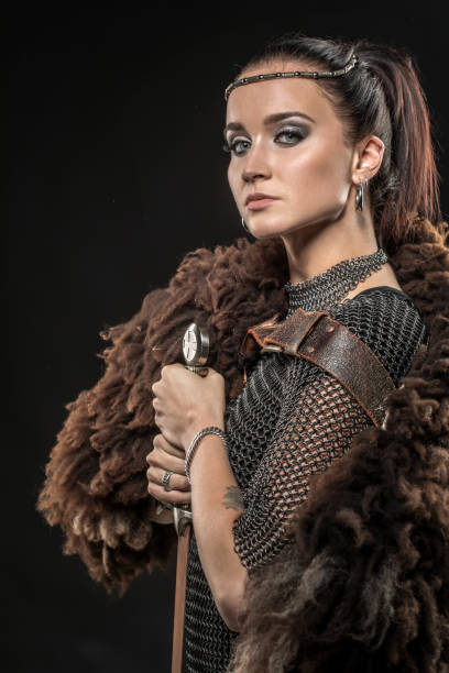istock Sword wielding viking warrior female in studio shot 1035439034