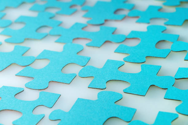 istock Elements of a puzzle of blue color on a white table. 1035439092