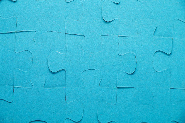 istock Elements of a puzzle of blue color on a white table. 1035439132