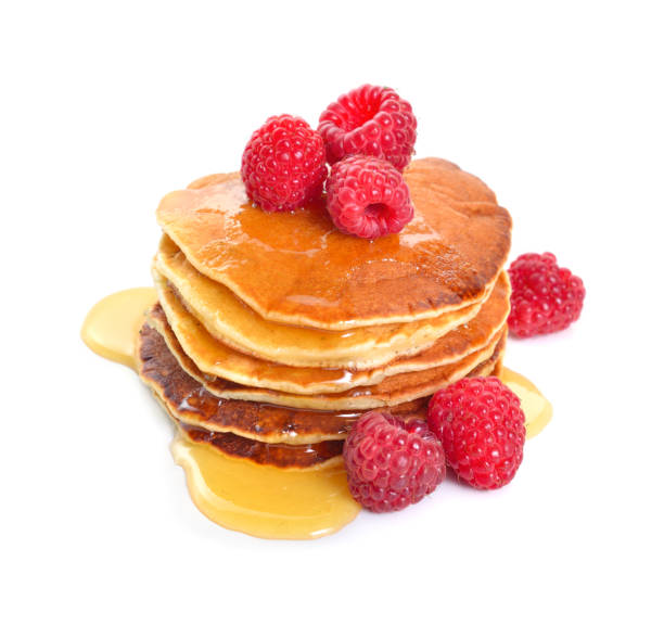 istock Pancakes with raspberries and honey or maple syrup. Isolated on white background 1035439238