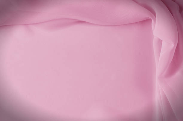 istock Texture, background, pattern. Silk fabric pale pink, abstract folds 1035440240