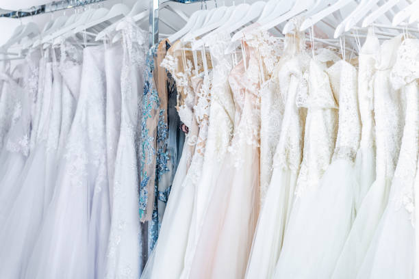 istock Wedding dresses hanging in boutique 1035448460