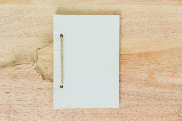 istock handmade book white paper texture abstract on wooden background. 1035449510