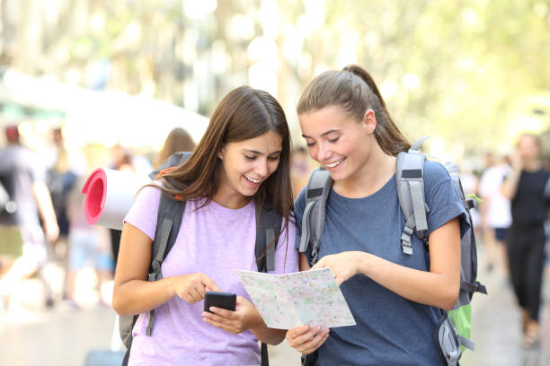 istock Happy backpacker friends searching location 1035451932