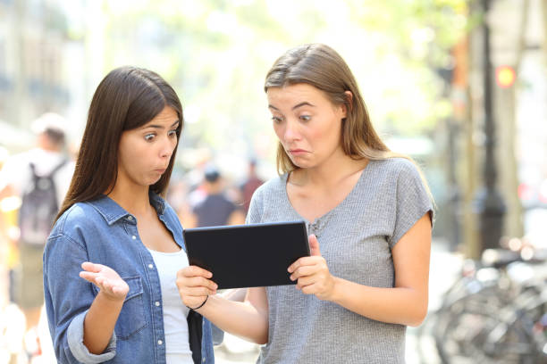 istock Confused friends reading online content in a tablet 1035452296