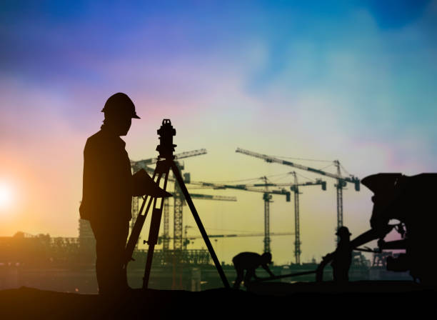 istock Silhouette of engineer and construction team working at site over blurred background for industry background with Light fair.Create from multiple reference images together. 1035456298