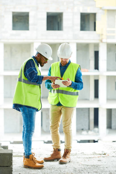 istock Busy coworkers discussing plan of construction work 1035456866
