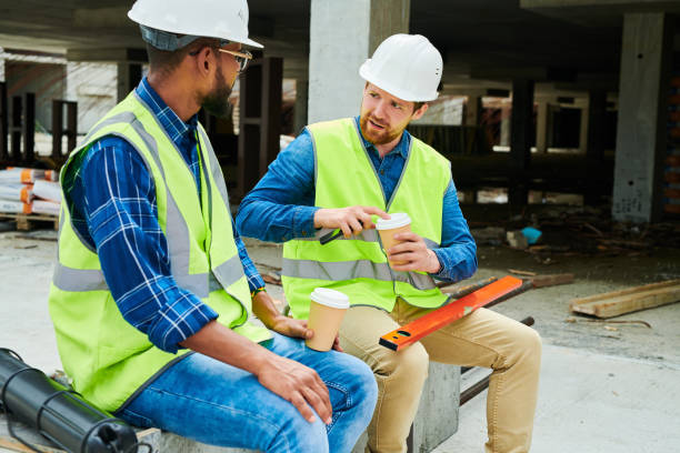 istock Puzzled worker talking to colleague about building project 1035456964