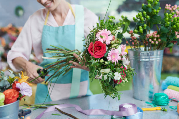 istock Florist cutting flower stems 1035457412