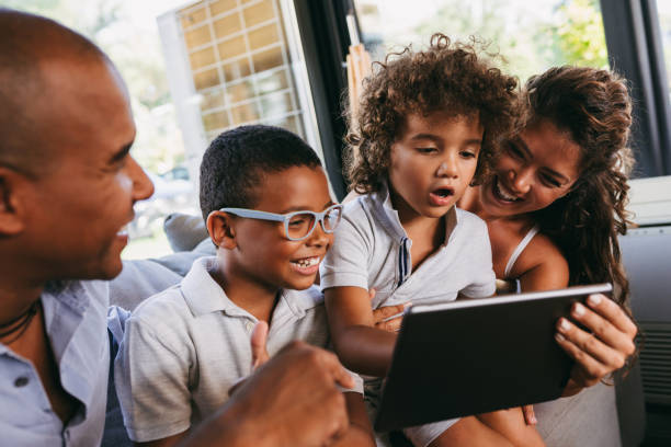 istock Happy family using digital tablet in cafe 1035457528