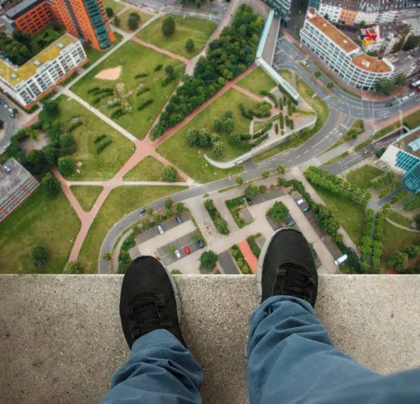 A man at the edge of a skyscraper