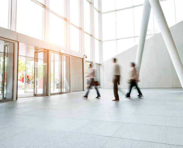 istock Group of people walking in modern building lobby 1035478780