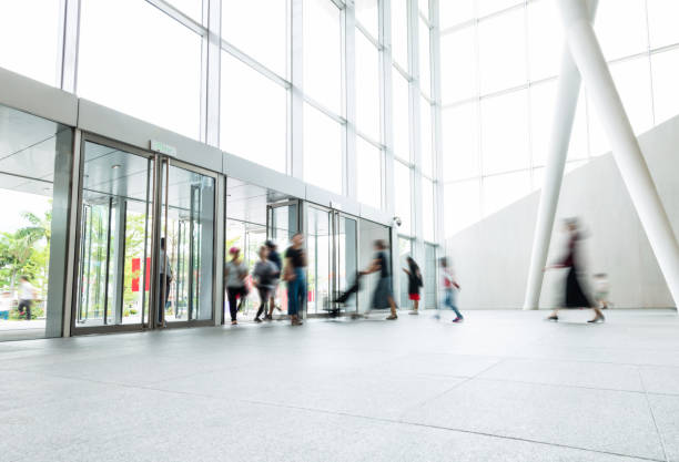 istock Group of people walking in modern building lobby 1035478784