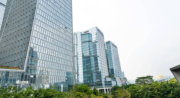 istock Business skyscraper and green trees 1035483874