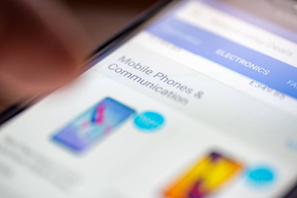 istock Human finger thumb over Mobile Phones and Communication category button link on shopping app on smartphone screen closeup 1035487598