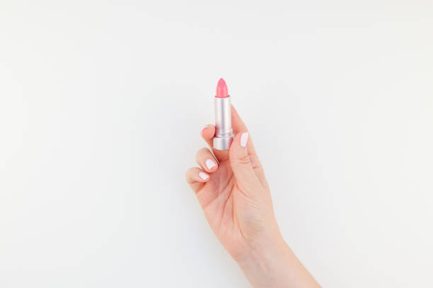istock Woman hand with pink lipstick 1035487702