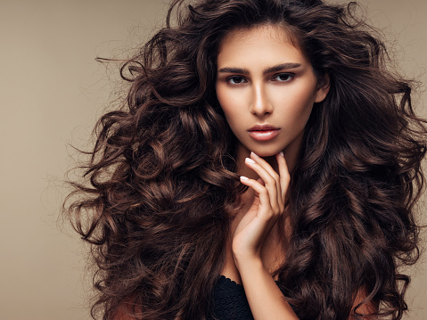 Beautiful girl with lush curly hairstyle